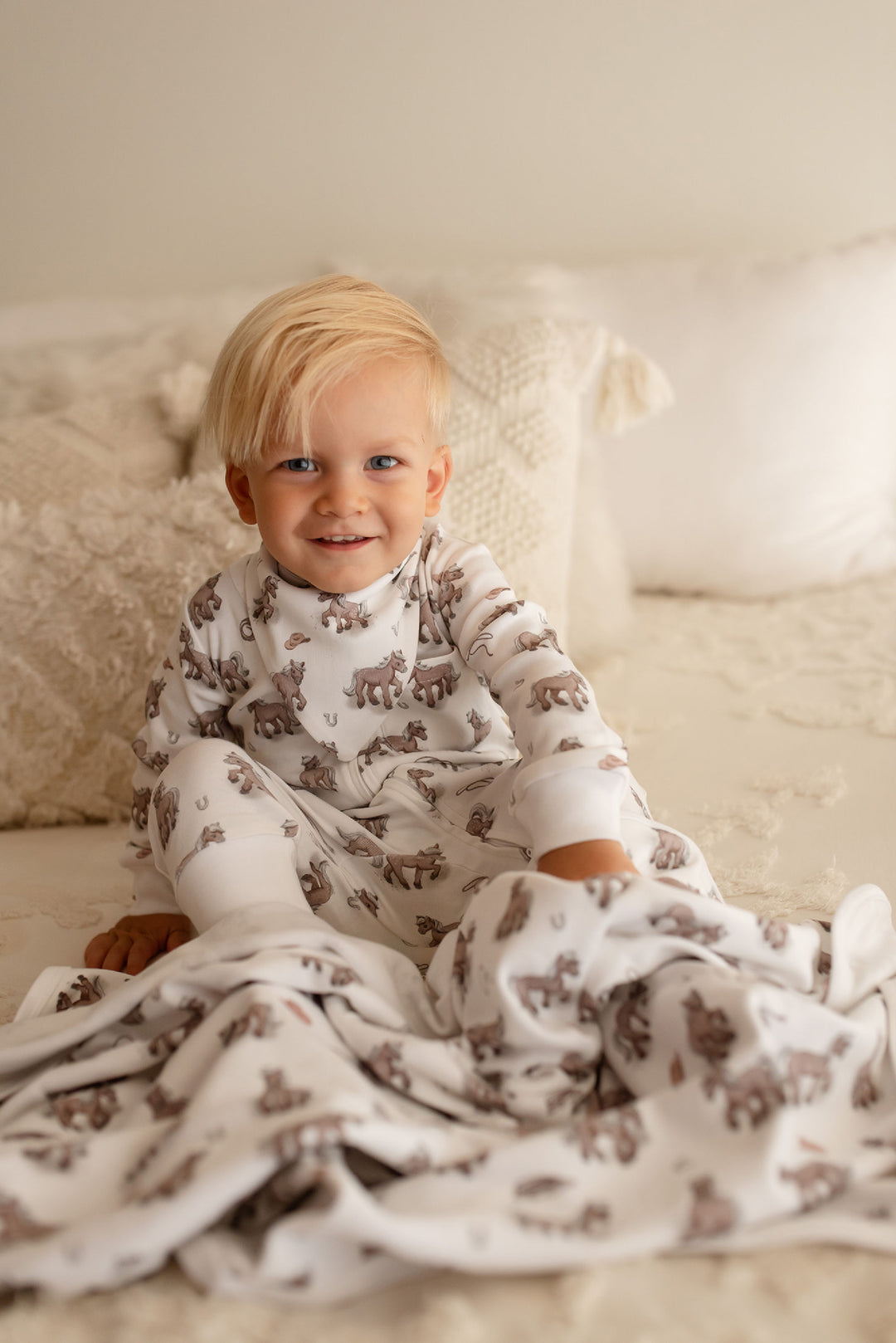 Child wearing Organic Blanket in Little Lasso.