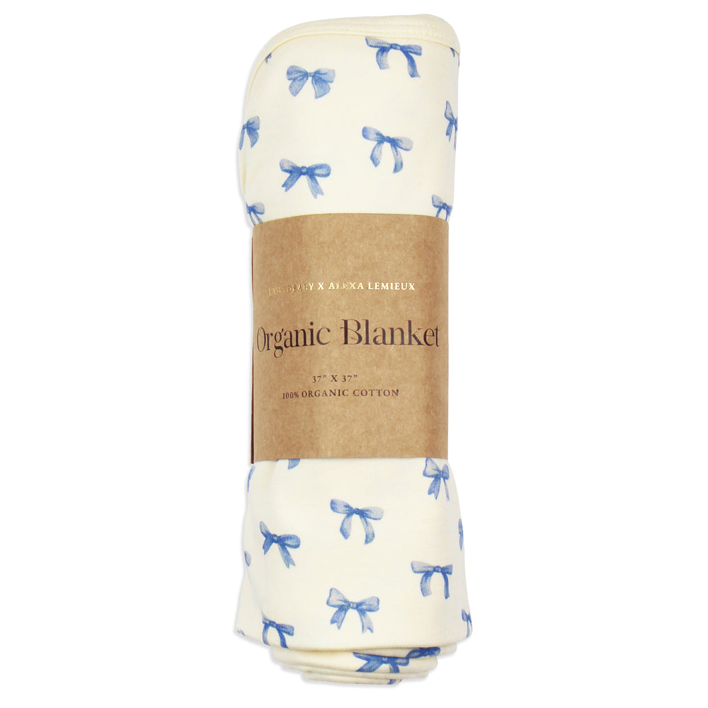 flat image of swaddle blanket in blue ribbon print, rolled neatly and placed inside kraft color card stock wrap sleeve