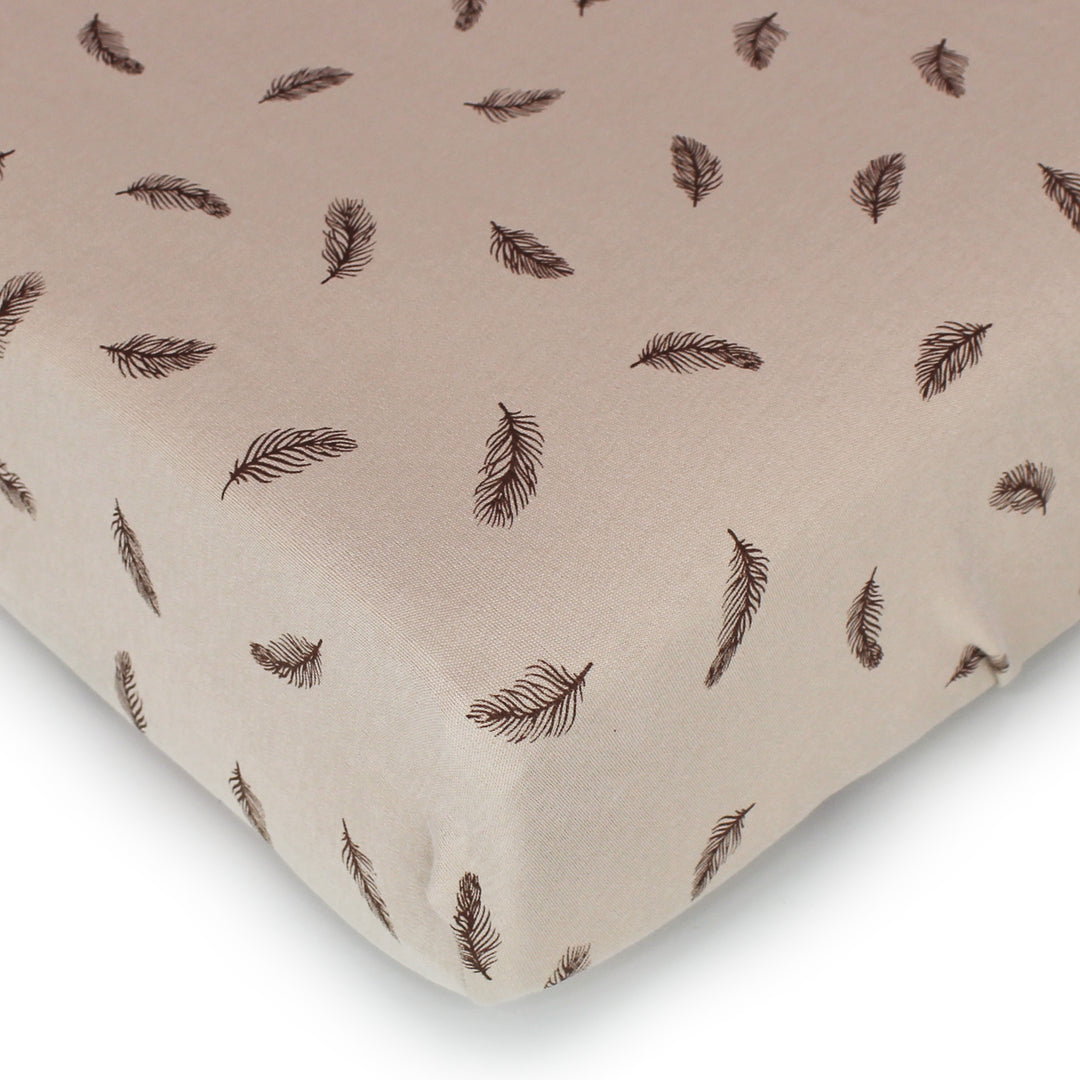 cropped image views of crib mattress corner showing the oatmeal feather sheet print