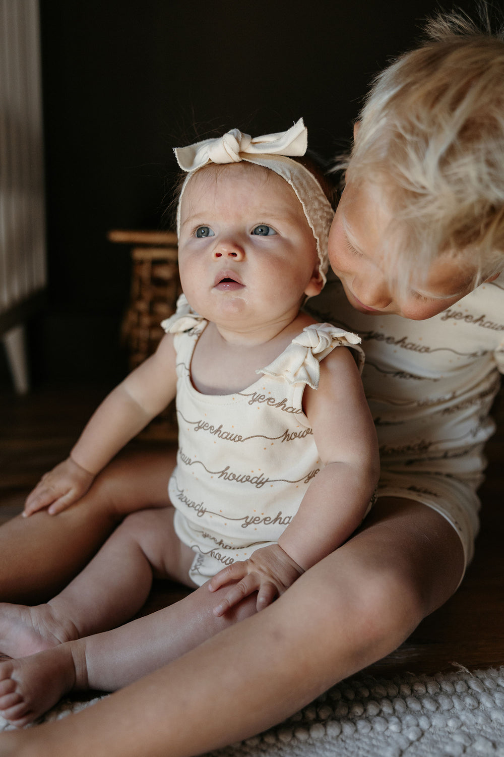 Child wearing Organic Bowtie Shoulder Bodysuit in Howdy.