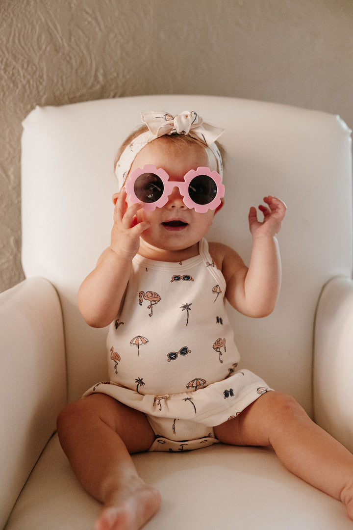 Child wearing Skirted X-Back Bodysuit in Flamingo.