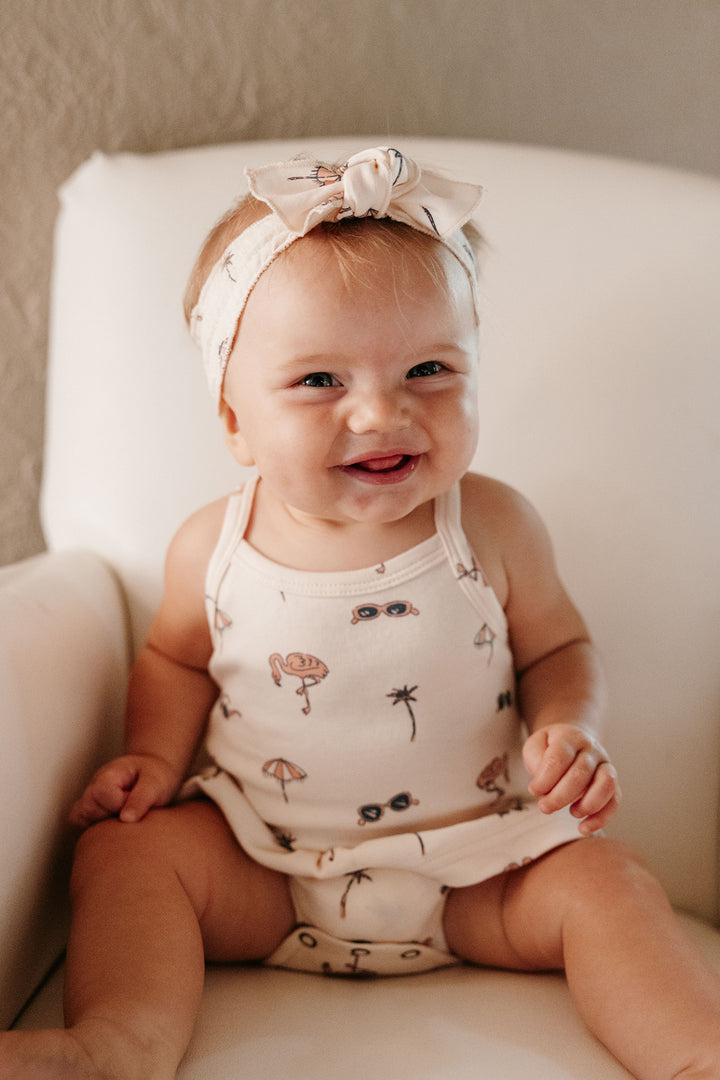 Child wearing Skirted X-Back Bodysuit in Flamingo.
