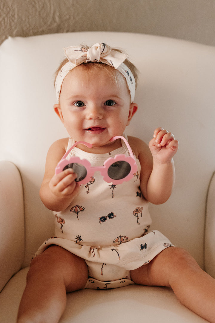 Child wearing Skirted X-Back Bodysuit in Flamingo.