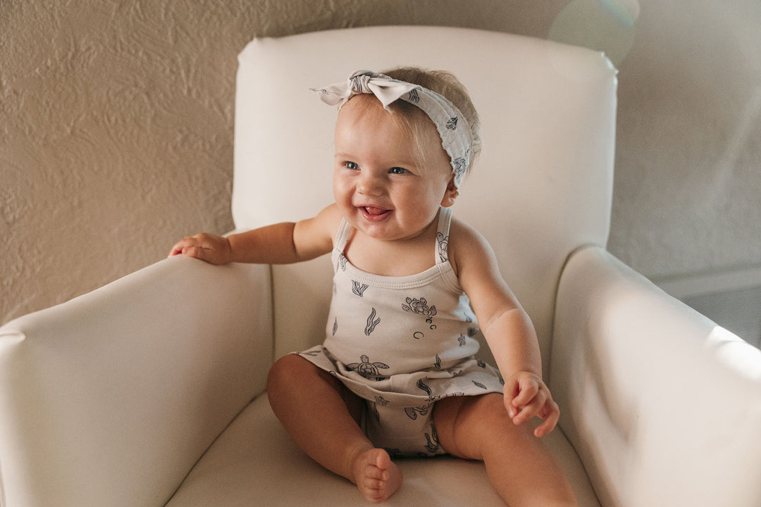 Child wearing Skirted X-Back Bodysuit in Sea Turtle.