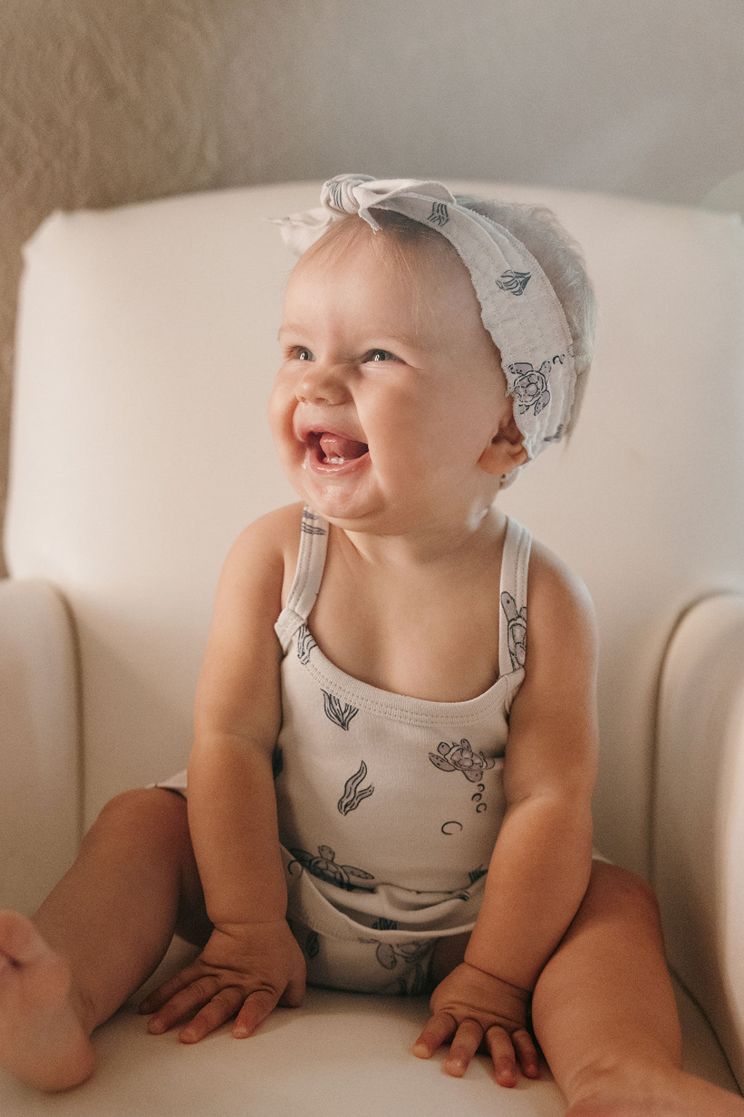 Child wearing Skirted X-Back Bodysuit in Sea Turtle.