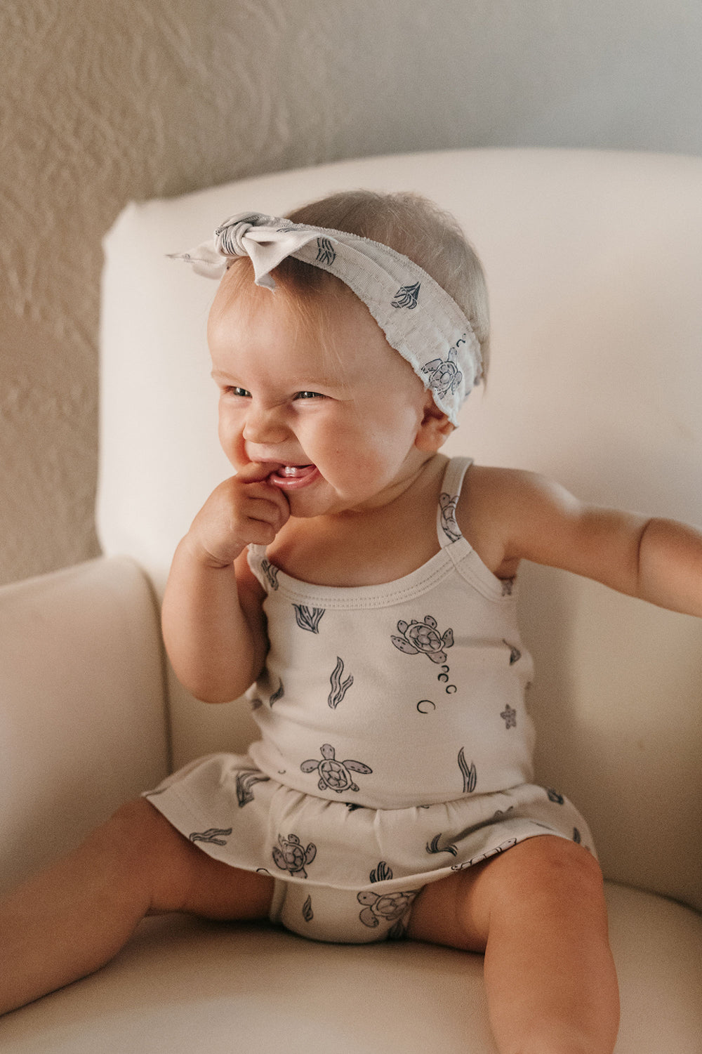 Child wearing Skirted X-Back Bodysuit in Sea Turtle.