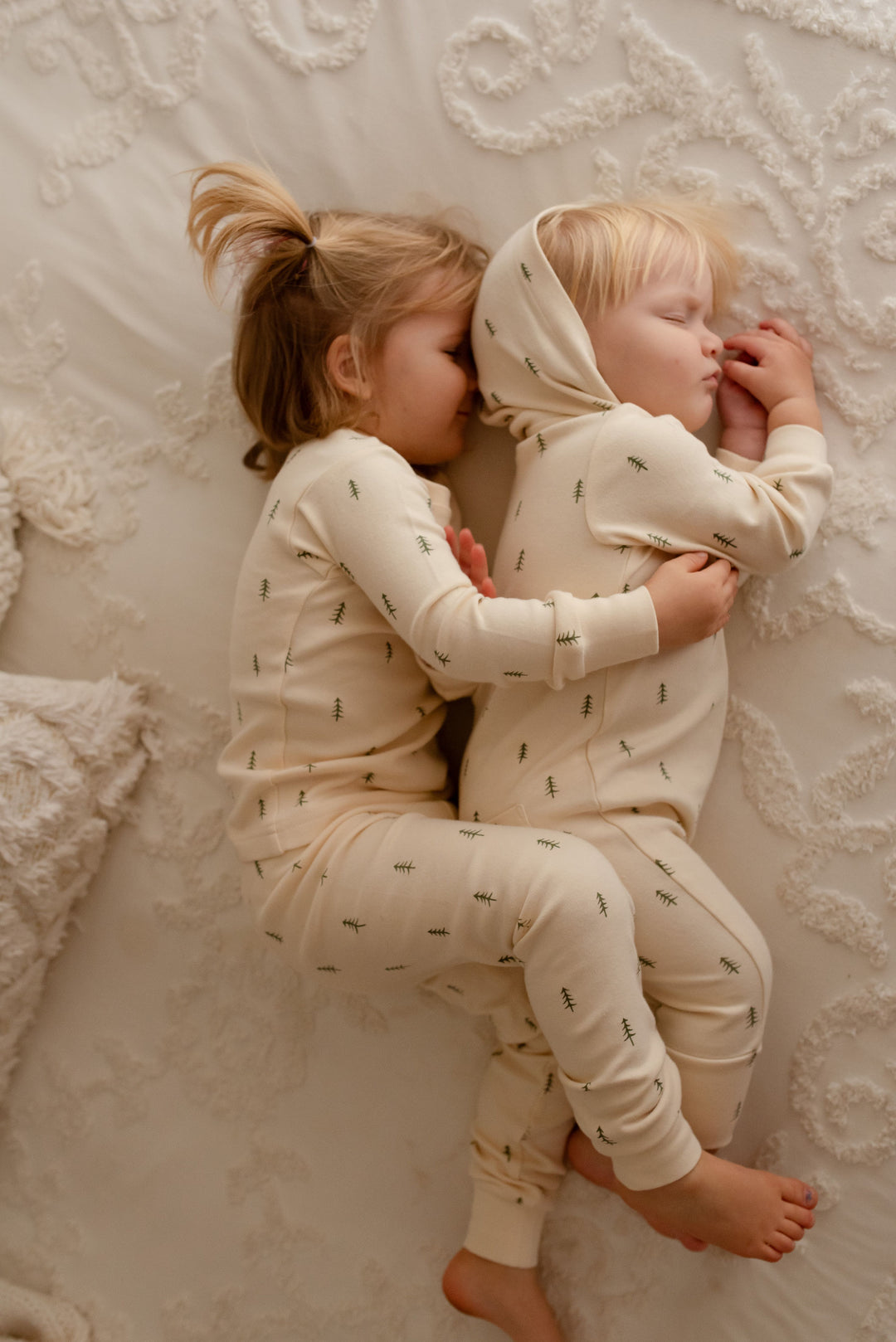 Child wearing Organic Zipper Romper in Buttercream Tree.