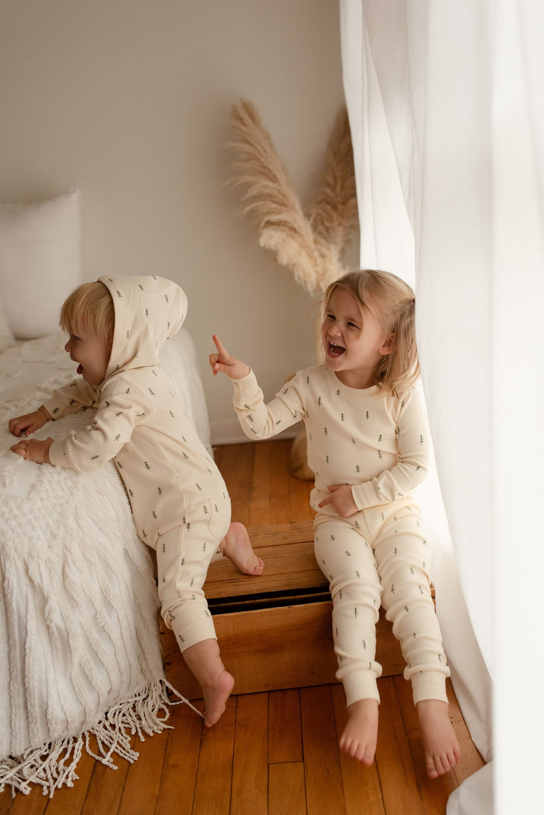 Child wearing Organic Zipper Romper in Buttercream Tree.