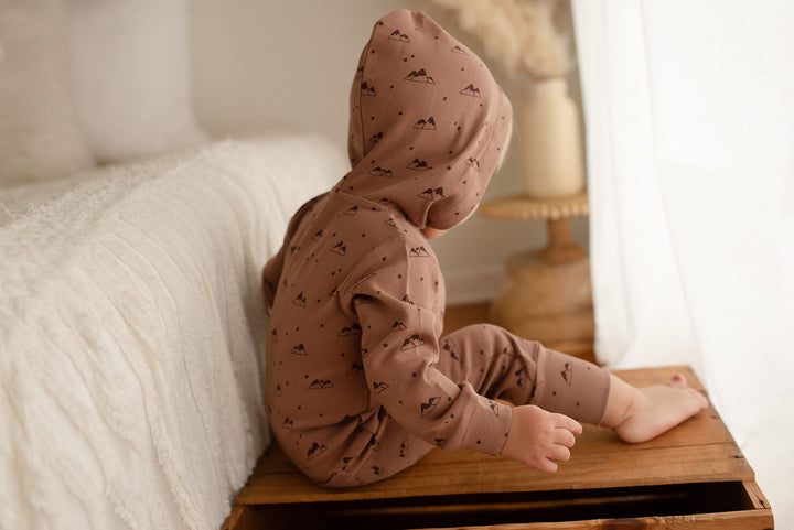 Child wearing Organic Zipper Romper in Latte Mountain.