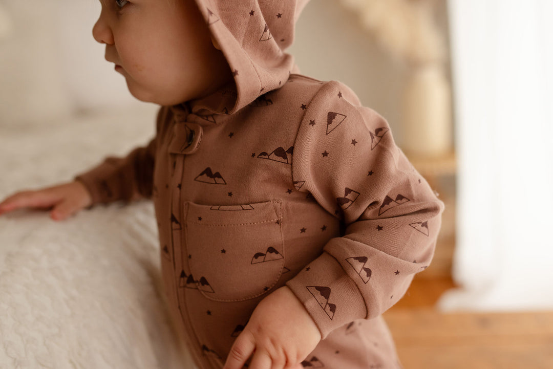 Child wearing Organic Zipper Romper in Latte Mountain.