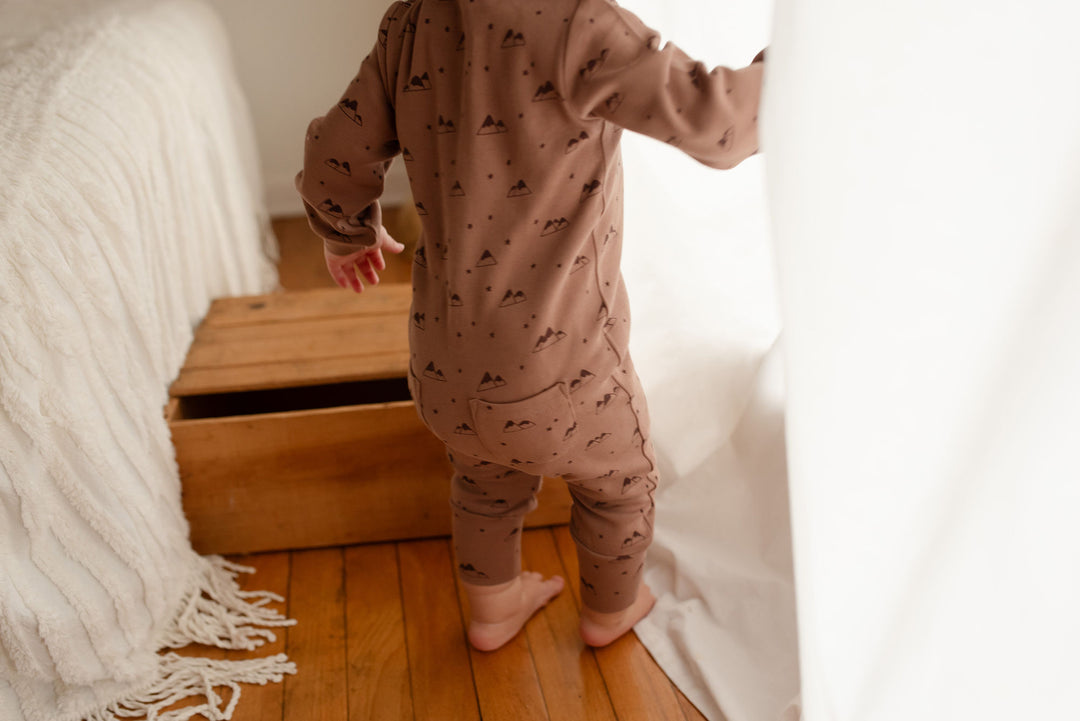 Child wearing Organic Zipper Romper in Latte Mountain.