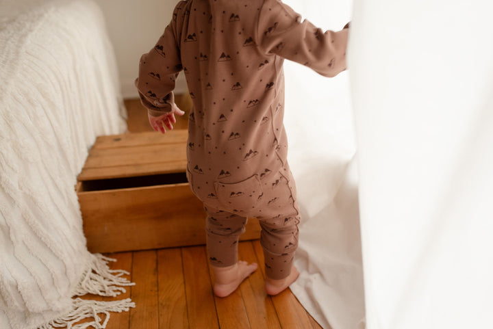Child wearing Organic Zipper Romper in Latte Mountain.
