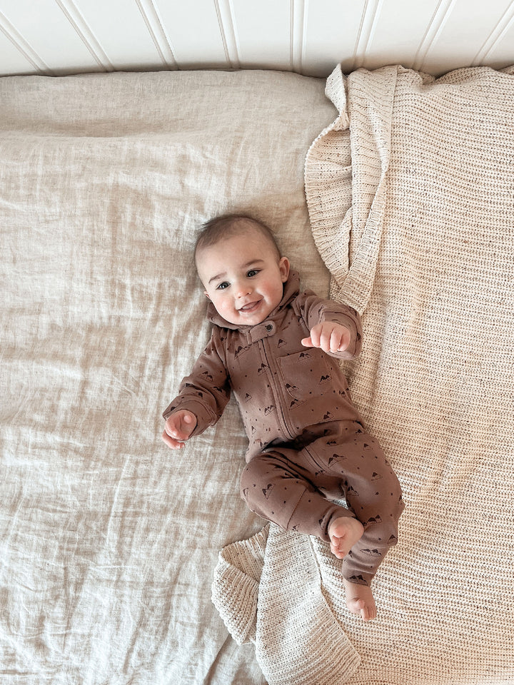 Child wearing Organic Zipper Romper in Latte Mountain.
