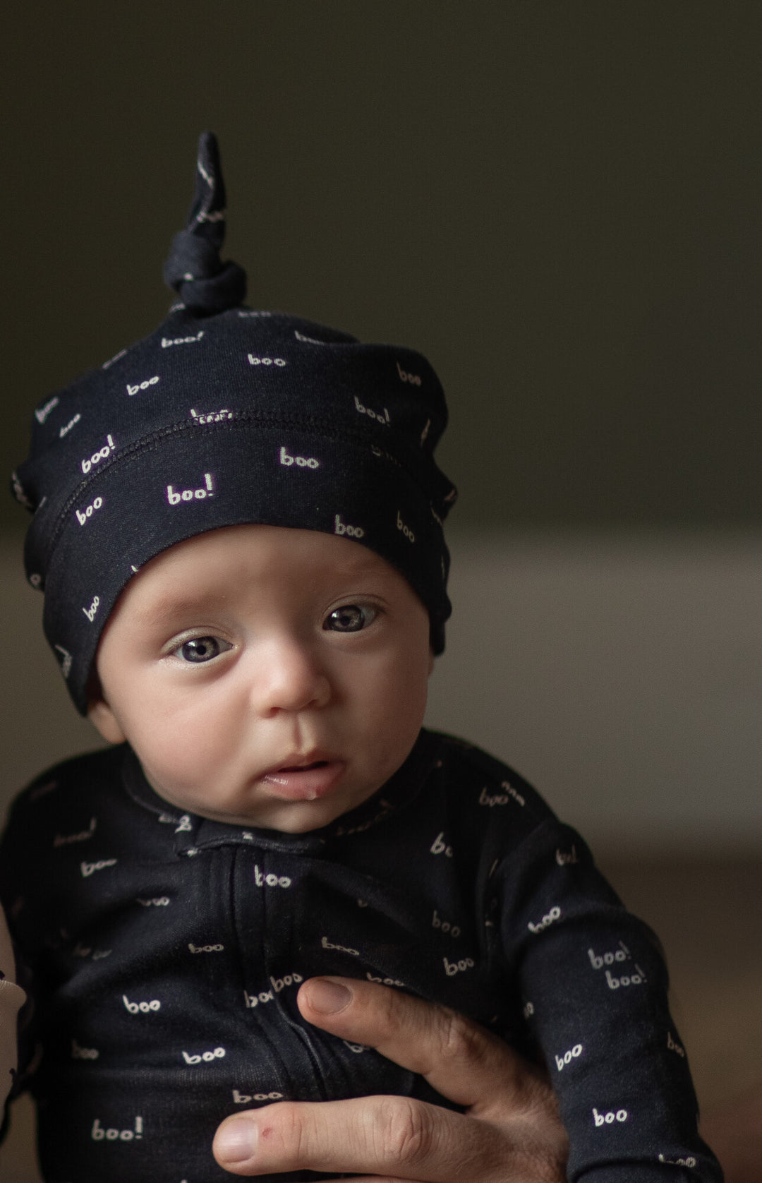 Child Wearing Organic Banded Top-Knot Hat in Bats.