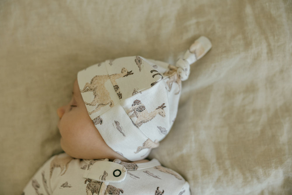 Child wearing Organic Knotted Hat in Llama.