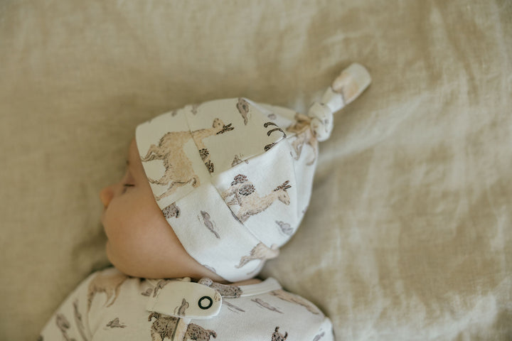 Child wearing Organic Knotted Hat in Llama.
