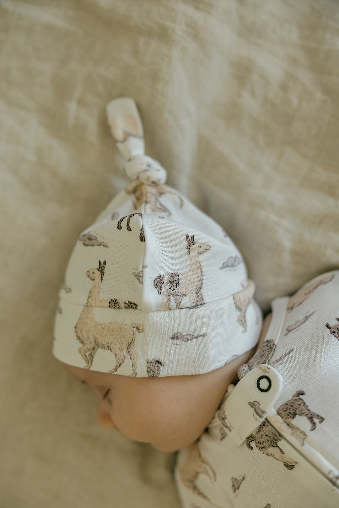 Child wearing Organic Knotted Hat in Llama.