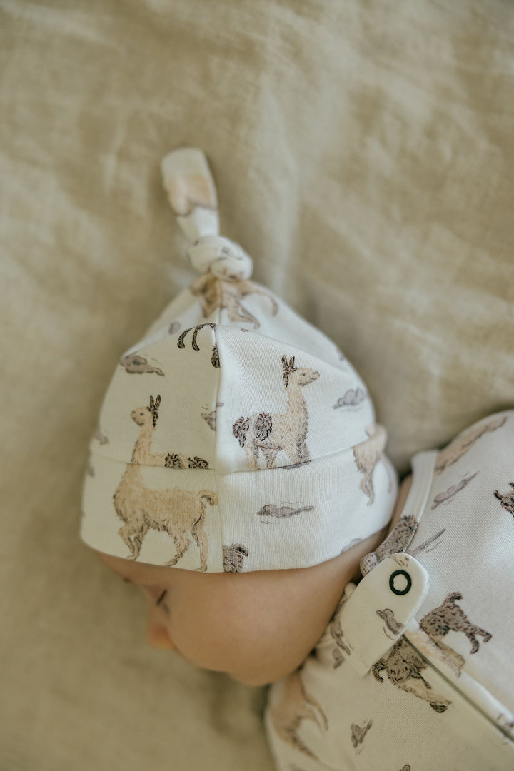 Child wearing Organic Knotted Hat in Llama.