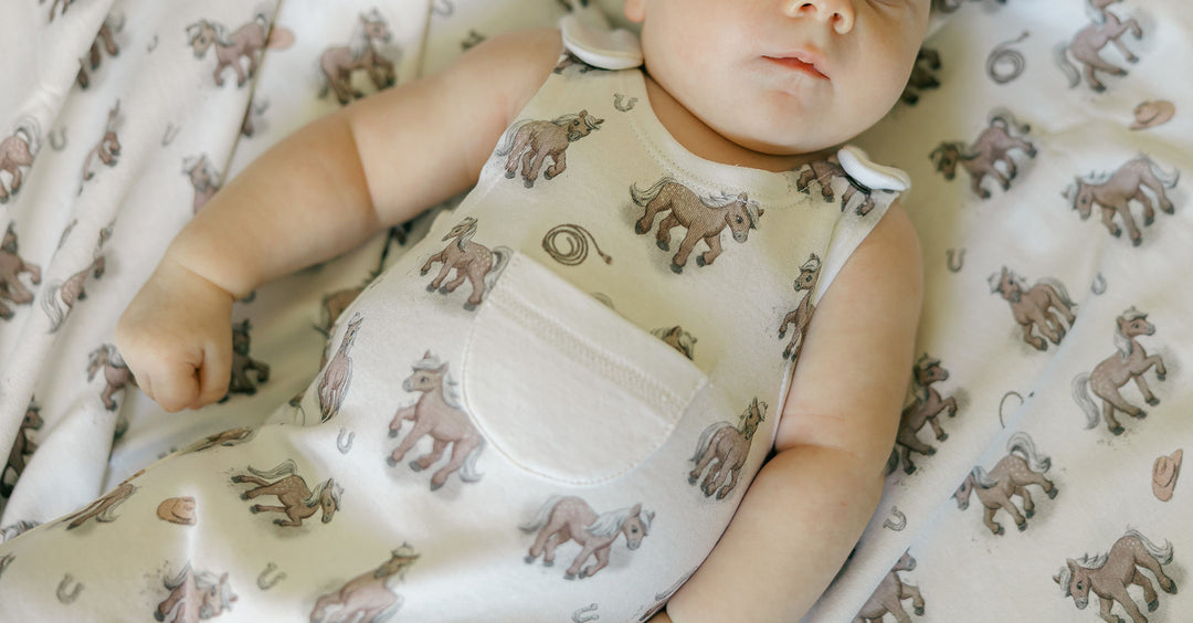 Child wearing Organic Sleeveless Romper in Little Lasso.