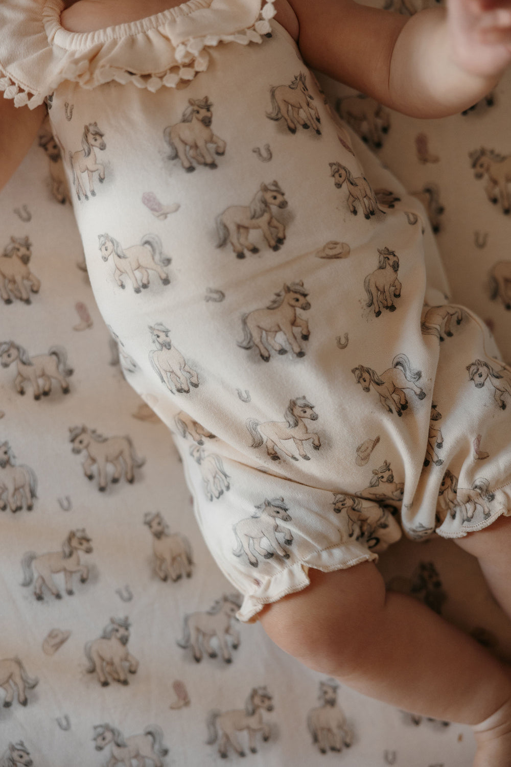 Child wearing Organic Bubble Romper in Blush Boots.