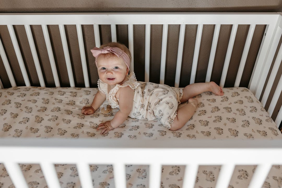 Child wearing Organic Bubble Romper in Blush Boots.
