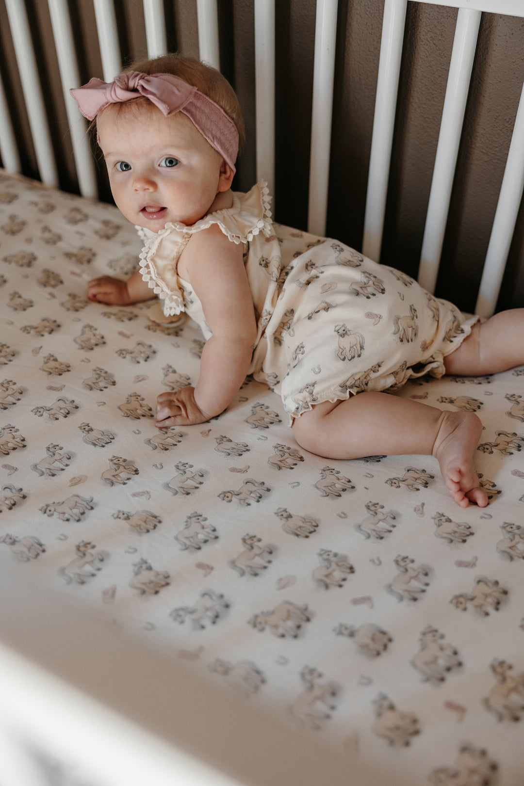 Child wearing Organic Bubble Romper in Blush Boots.