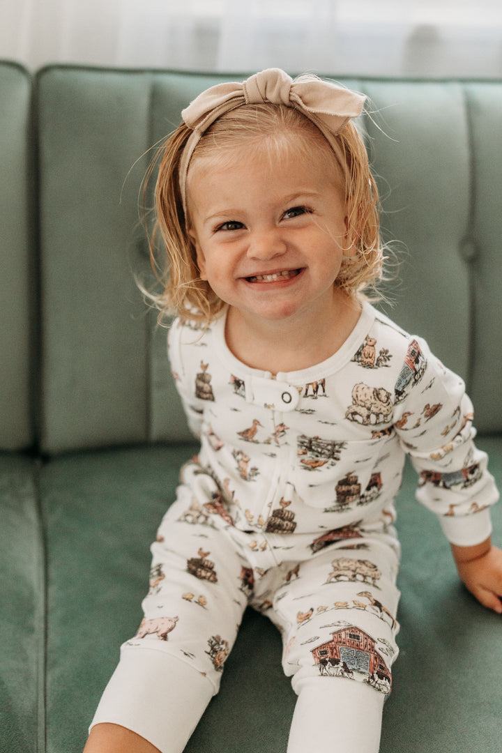 Child wearing Organic Footless 2-Way Zipper Romper in Farm Friends.
