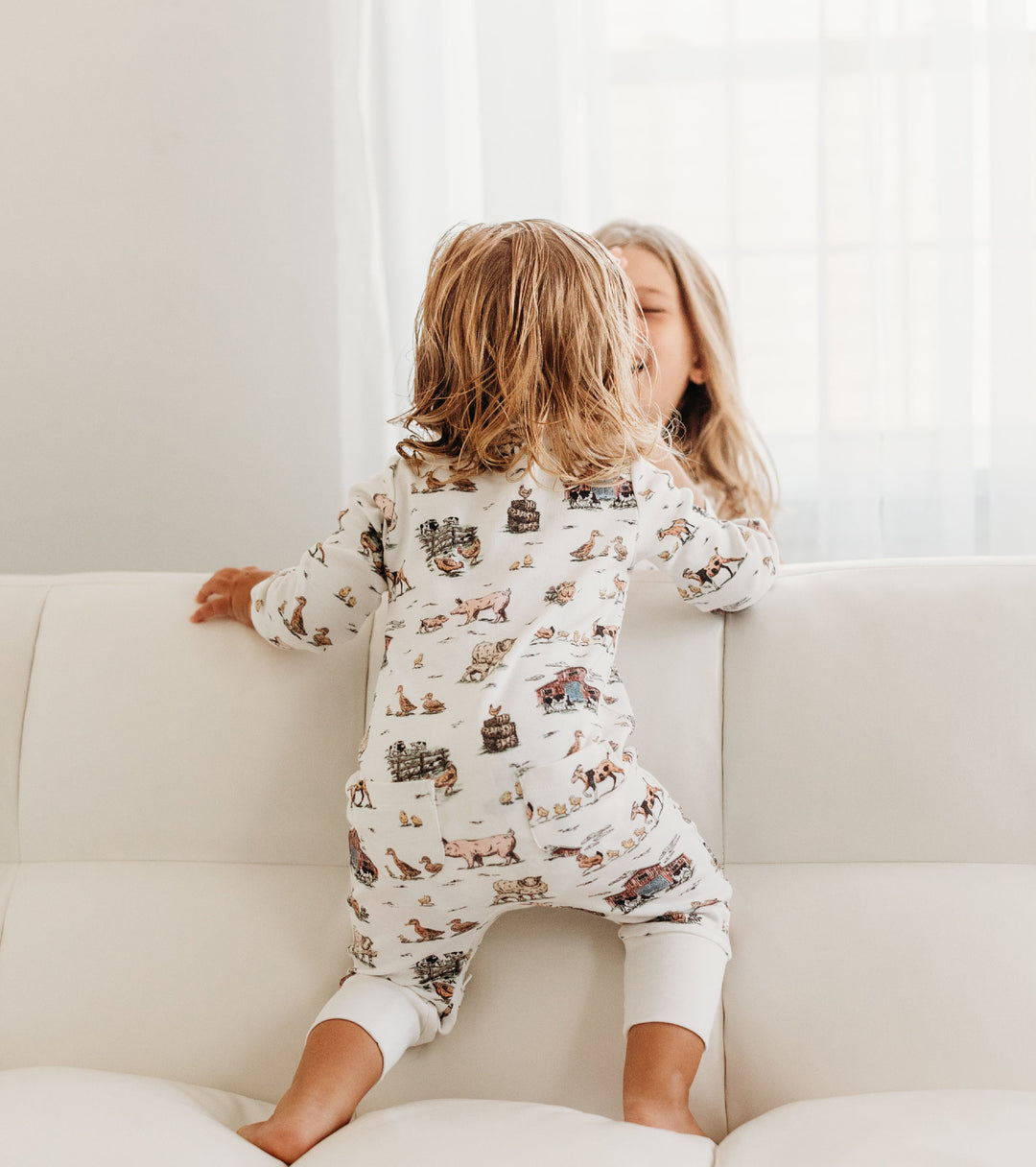 Child wearing Organic Footless 2-Way Zipper Romper in Farm Friends.
