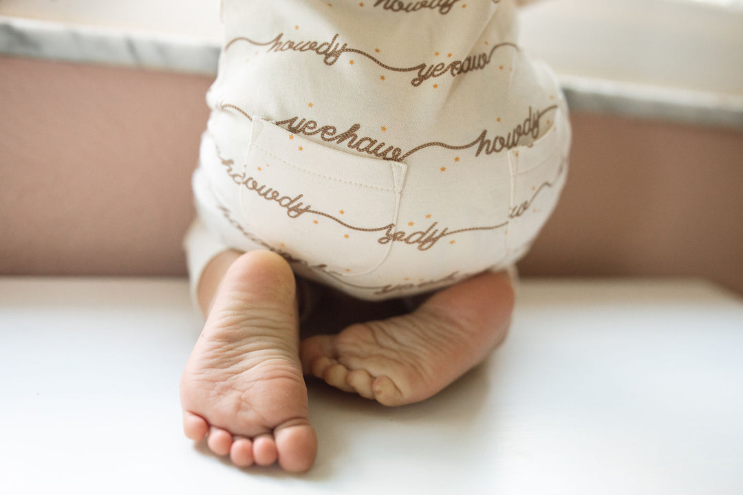 Child wearing Organic Footless 2-Way Zipper Romper in Howdy.