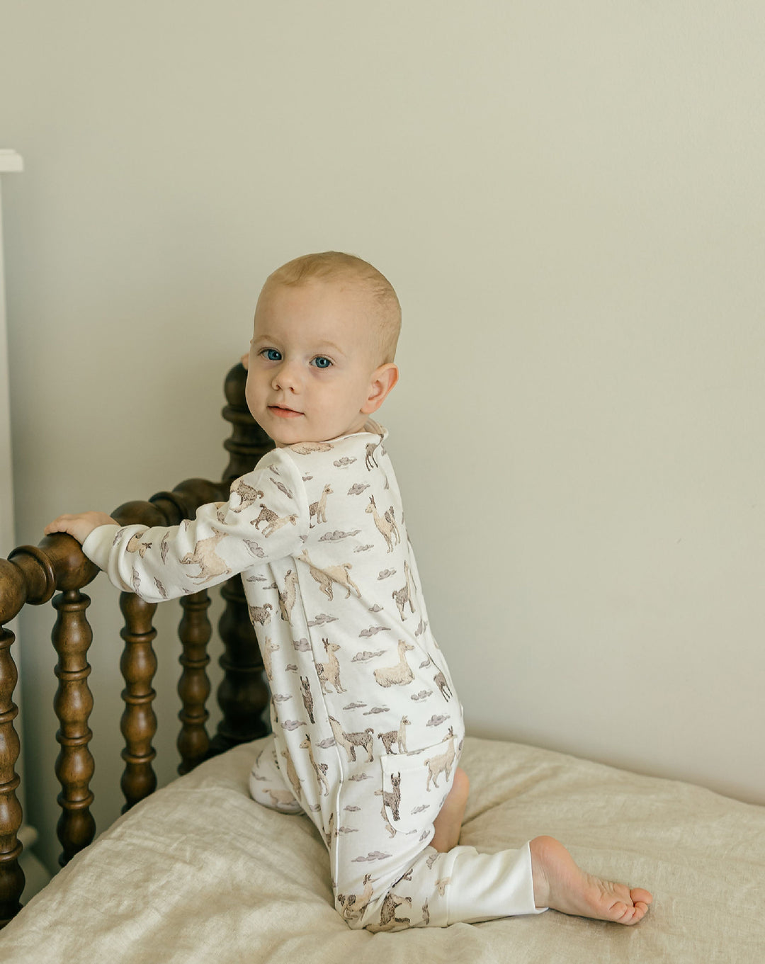 Child wearing Organic Footless 2-Way Zipper Romper in Llama.
