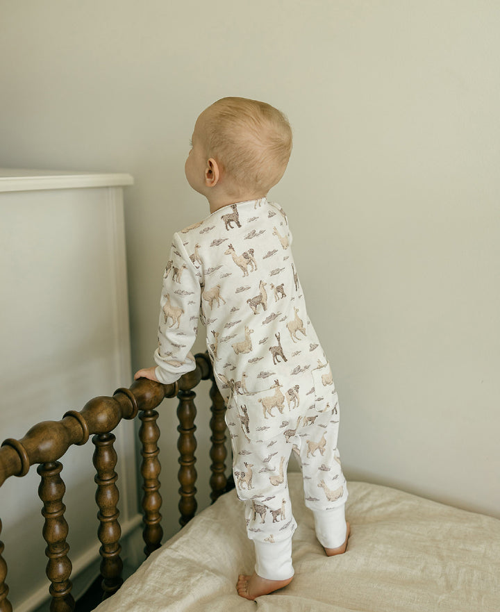 Child wearing Organic Footless 2-Way Zipper Romper in Llama.