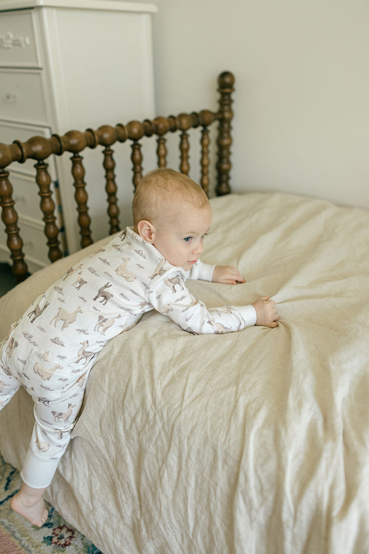 Child wearing Organic Footless 2-Way Zipper Romper in Llama.
