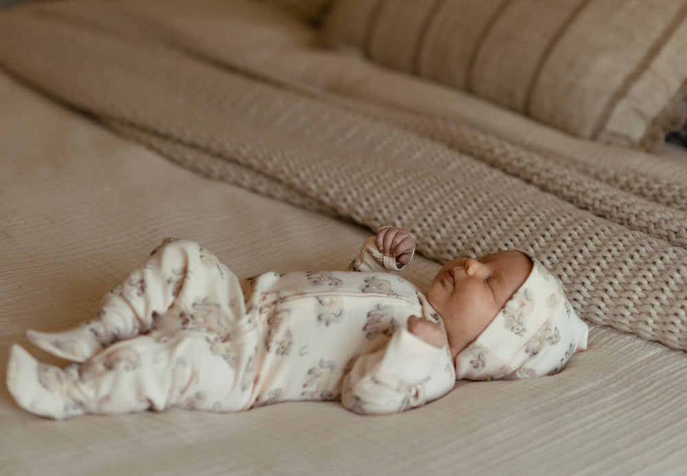 Child wearing Organic 2-Way Zipper Footie in Blush Boots.