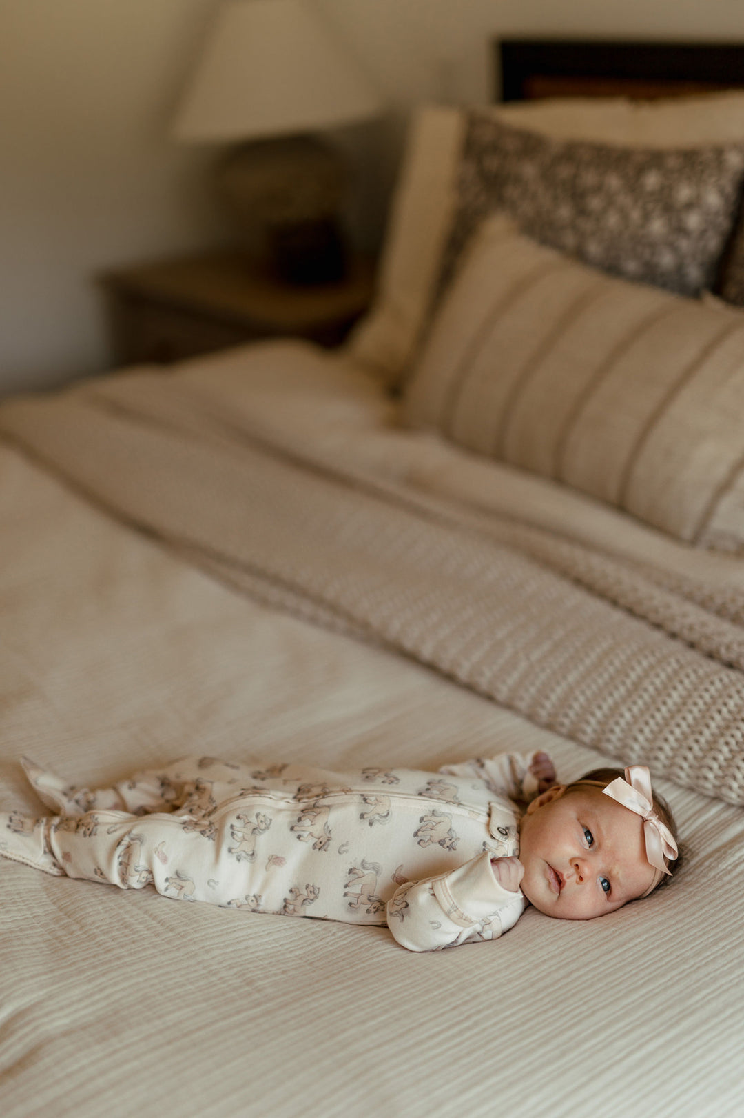 Child wearing Organic 2-Way Zipper Footie in Blush Boots.
