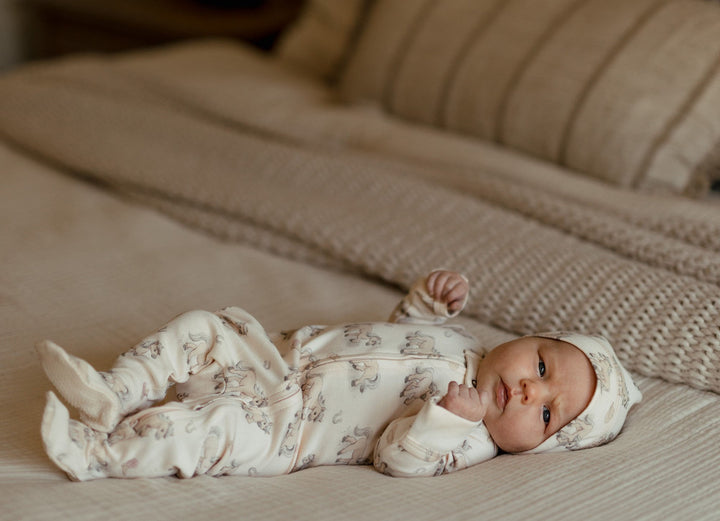 Child wearing Organic 2-Way Zipper Footie in Blush Boots.