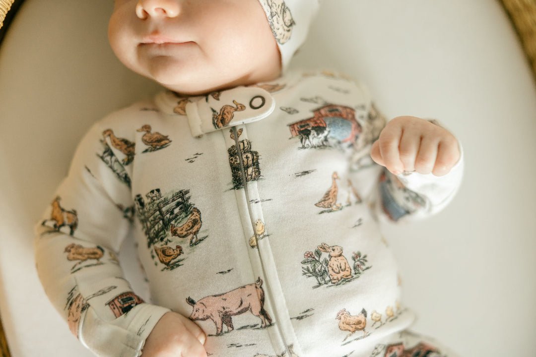 Child wearing Organic 2-Way Zipper Footie in Farm Friends.