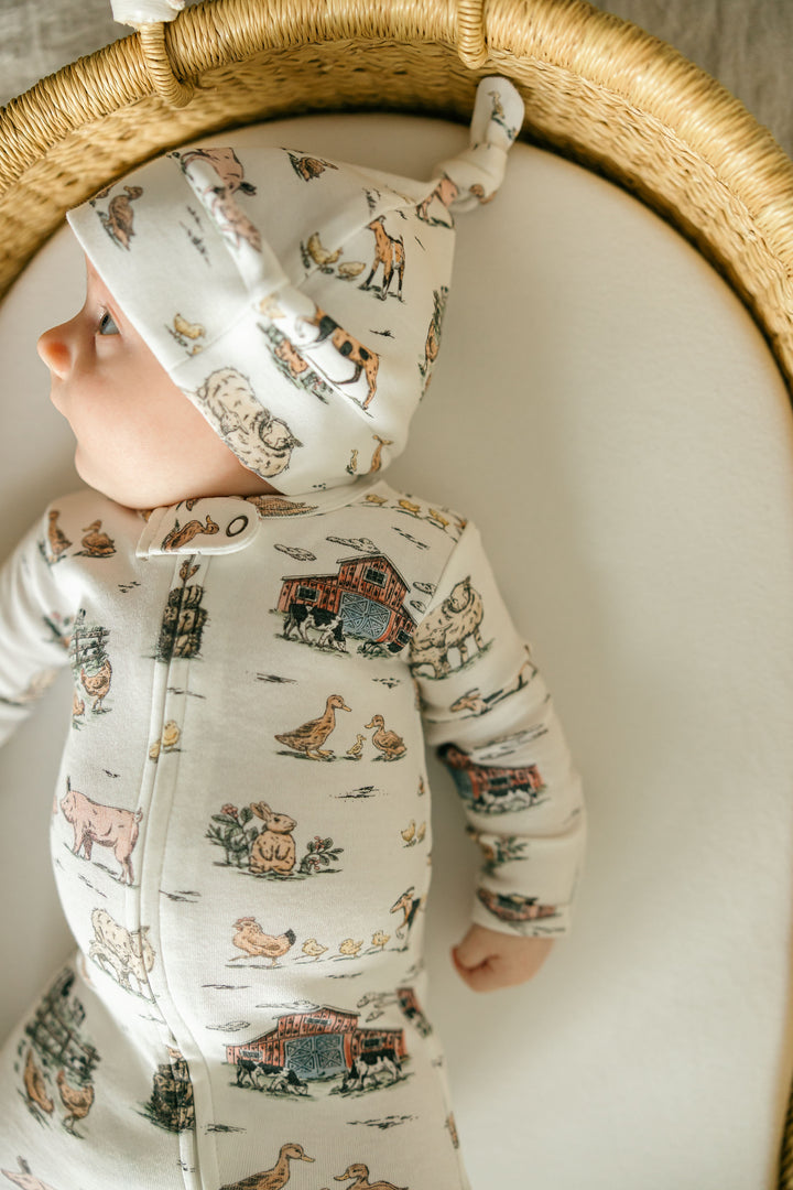 Child wearing Organic 2-Way Zipper Footie in Farm Friends.