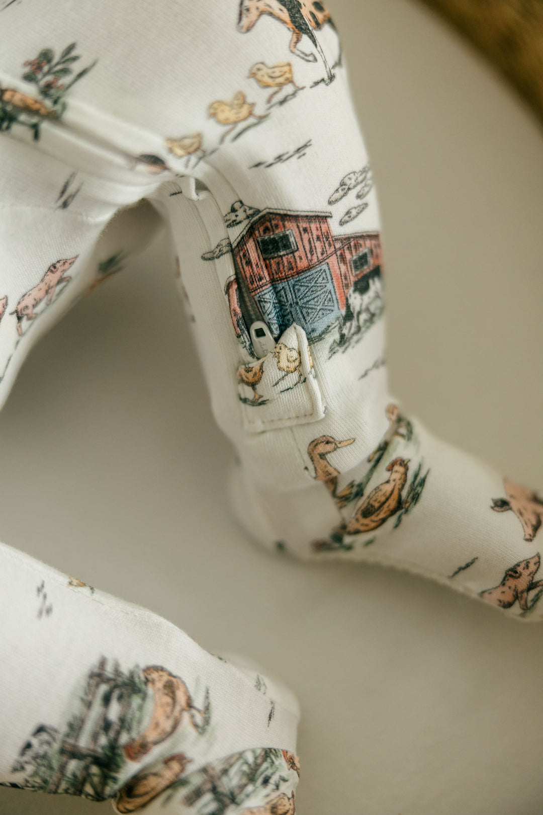 Child wearing Organic 2-Way Zipper Footie in Farm Friends.