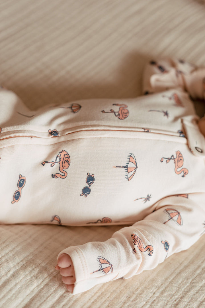 Child wearing Organic 2-Way Zipper Footie in Flamingo.