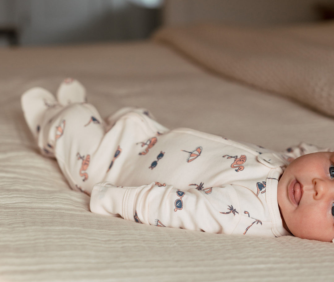 Child wearing Organic 2-Way Zipper Footie in Flamingo.