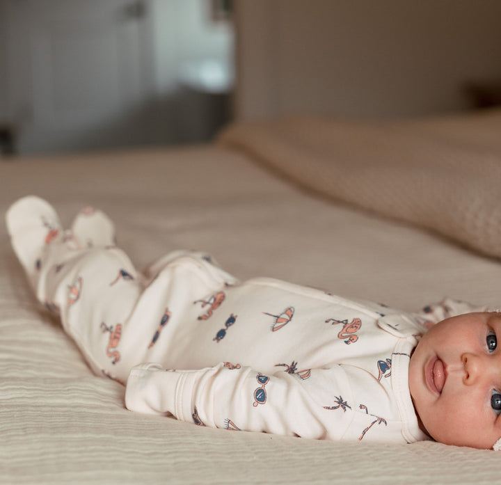 Child wearing Organic 2-Way Zipper Footie in Flamingo.