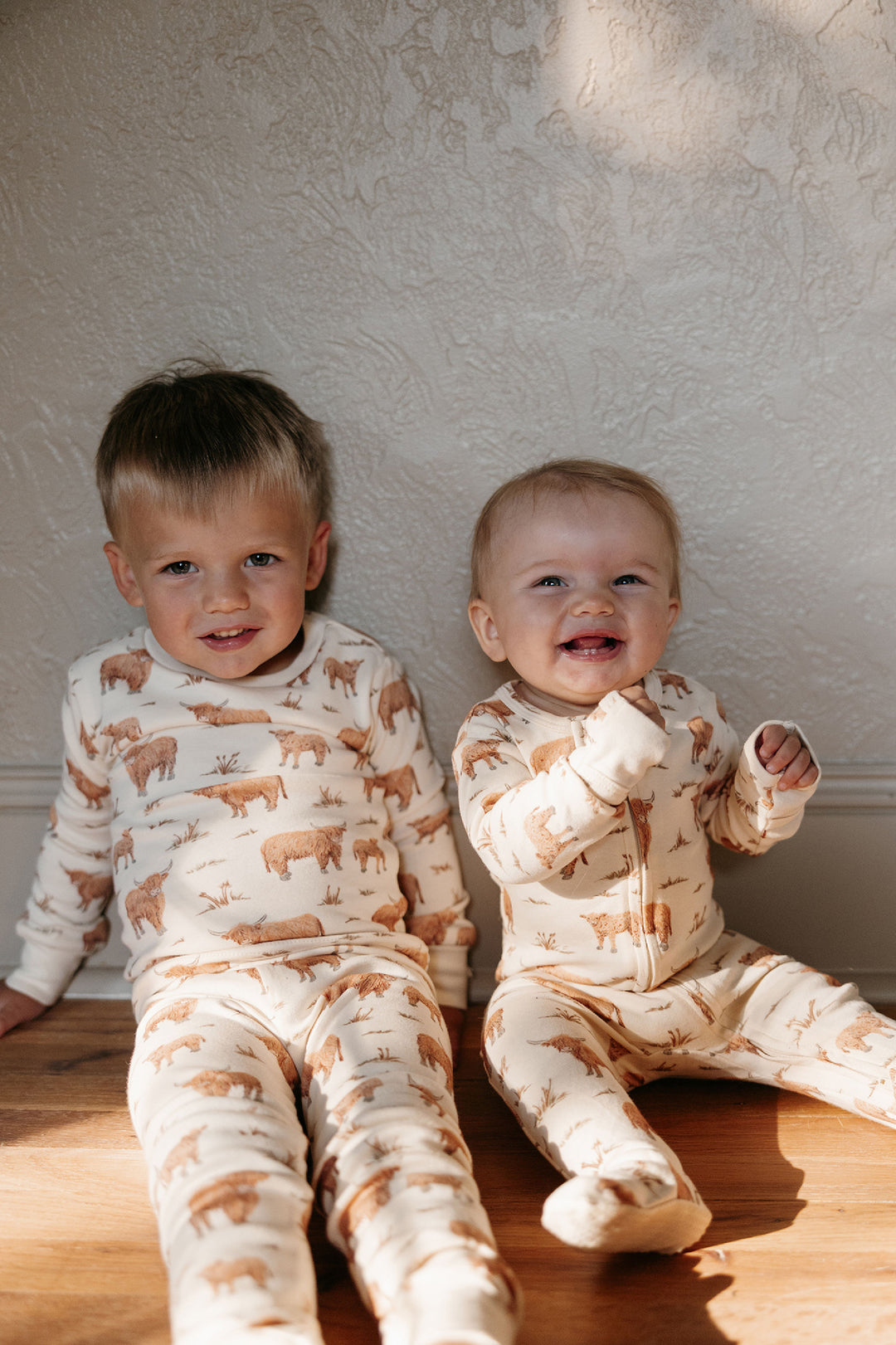 Child wearing Organic 2-Way Zipper Footie in Highland Cow.