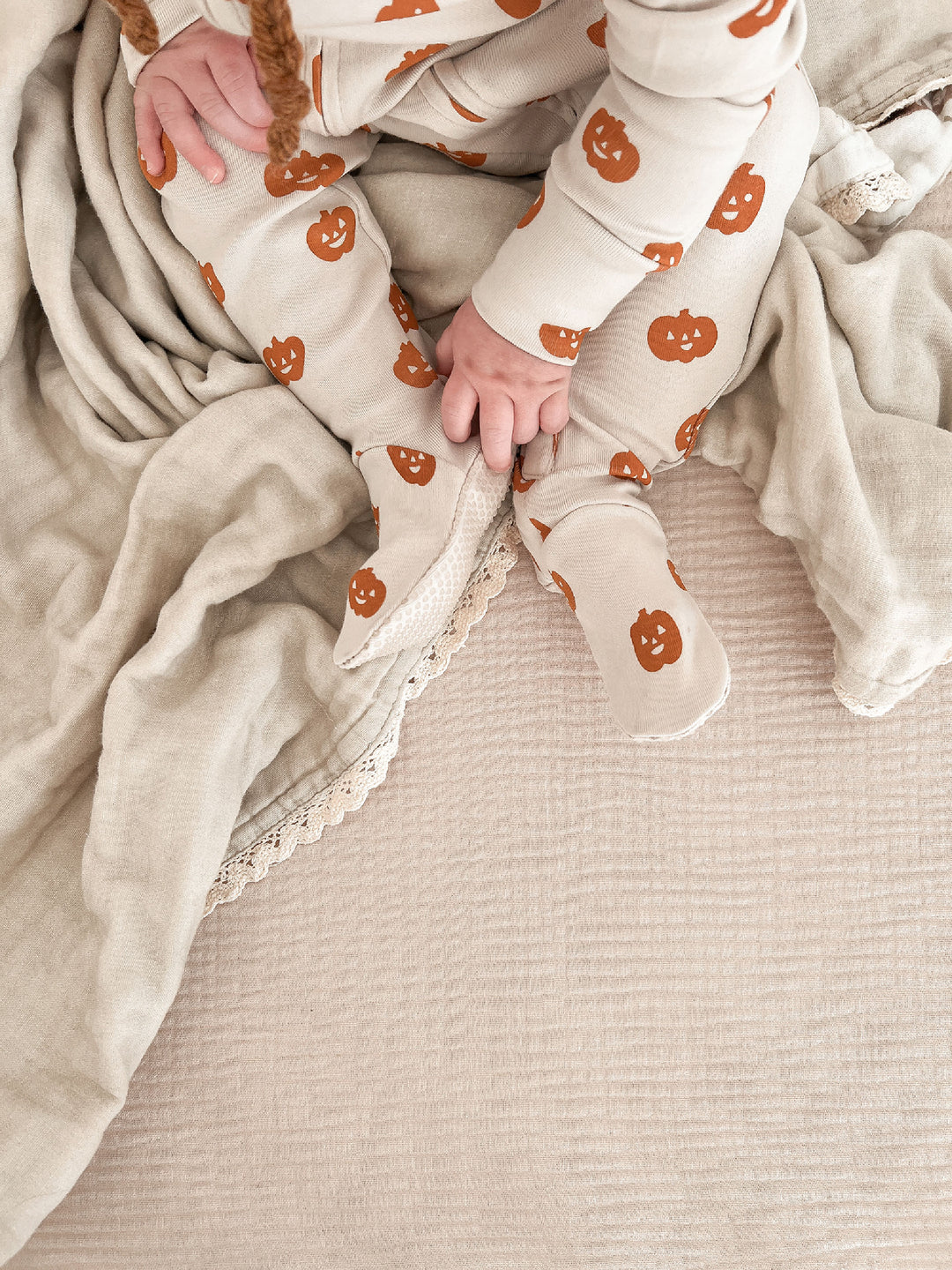 Child wearing Organic 2-Way Zipper Footie in Jack-o-Lanterns.