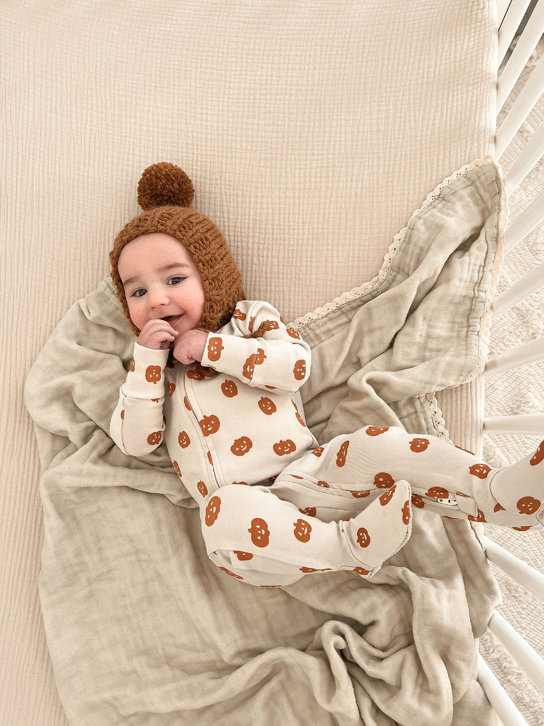 Child wearing Organic 2-Way Zipper Footie in Jack-o-Lanterns.