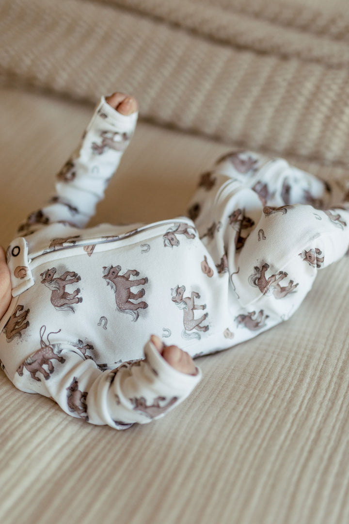 Child wearing Organic 2-Way Zipper Footie in Little Lasso.
