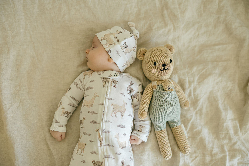 Child wearing Organic 2-Way Zipper Footie in Llama.