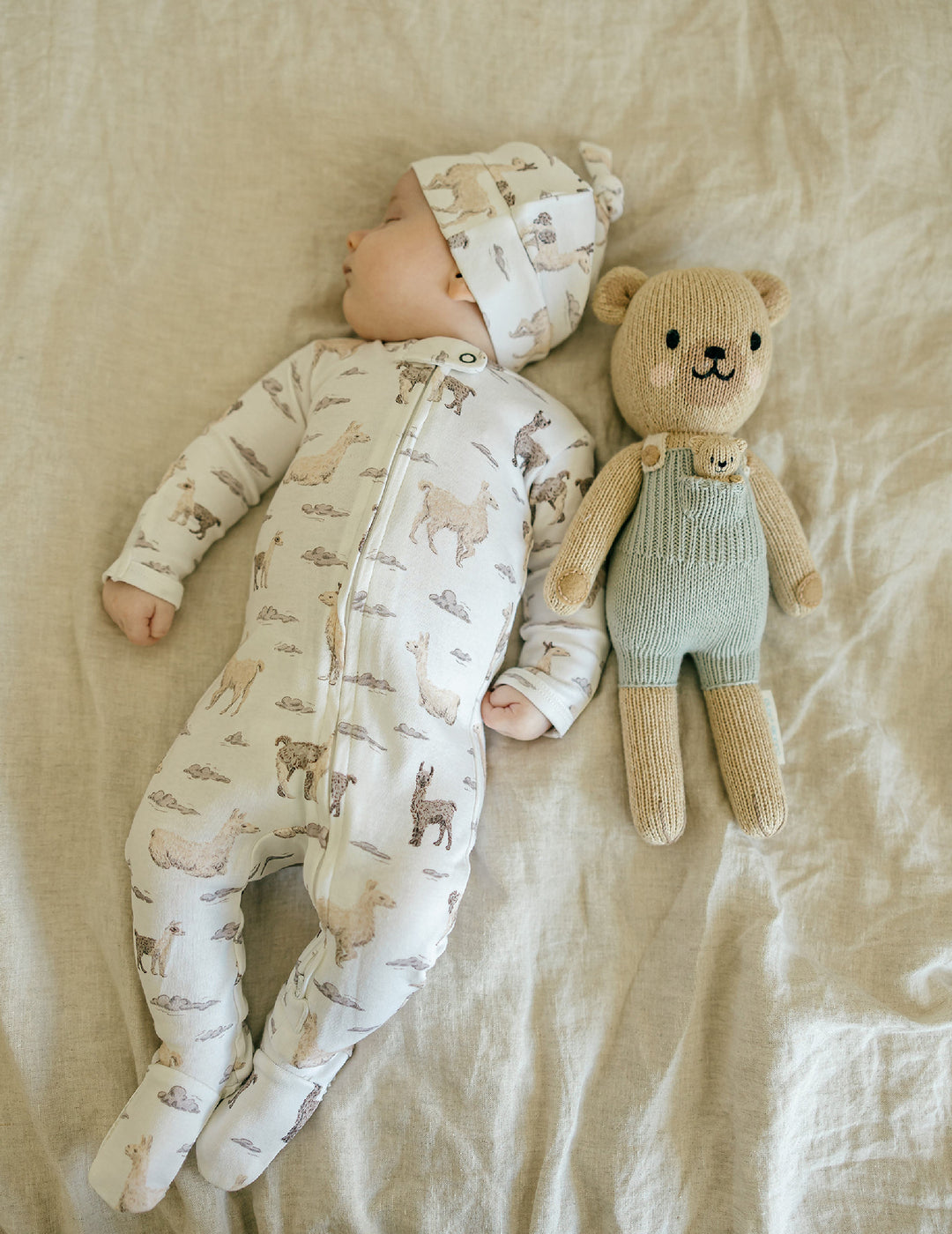 Child wearing Organic 2-Way Zipper Footie in Llama.