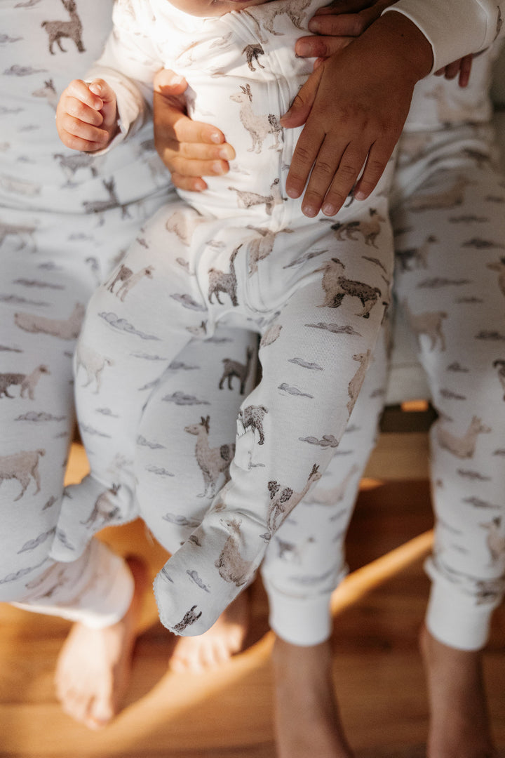 Child wearing Organic 2-Way Zipper Footie in Llama.