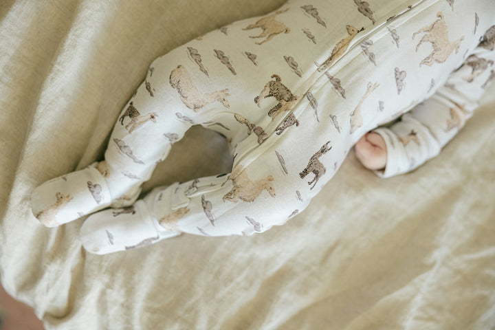 Child wearing Organic 2-Way Zipper Footie in Llama.