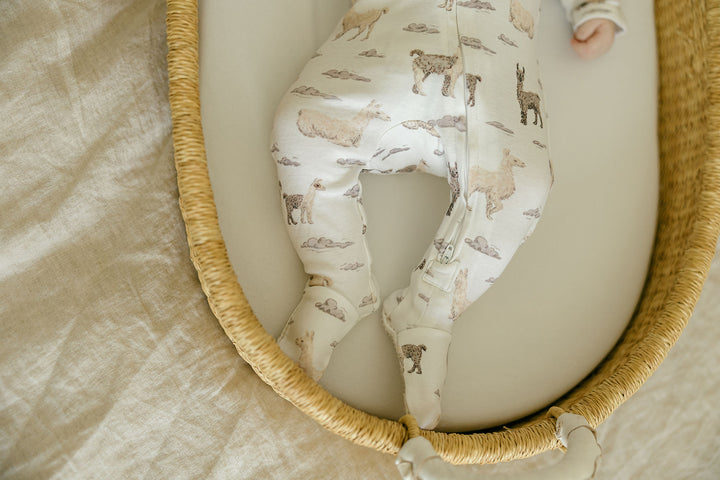 Child wearing Organic 2-Way Zipper Footie in Llama.